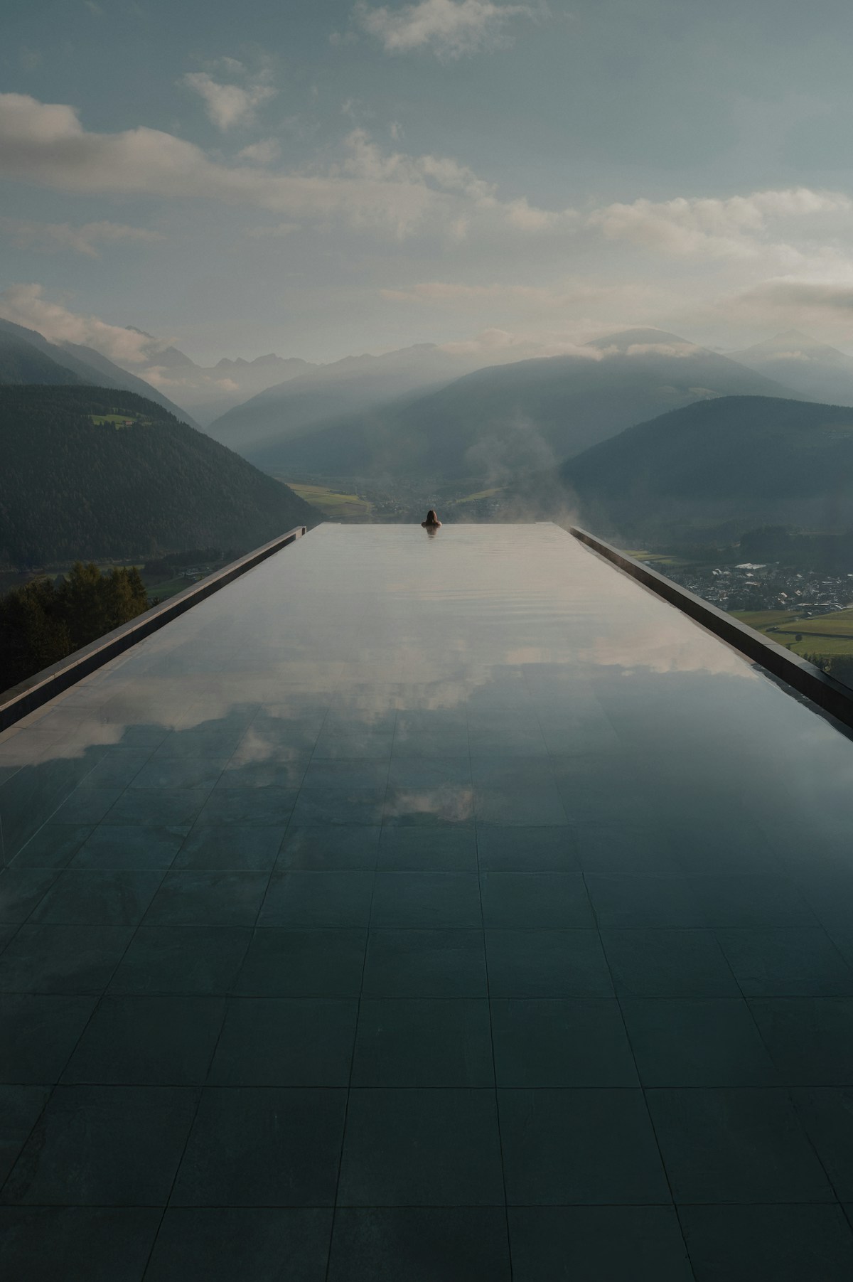 Infinity pool overlooking misty mountains