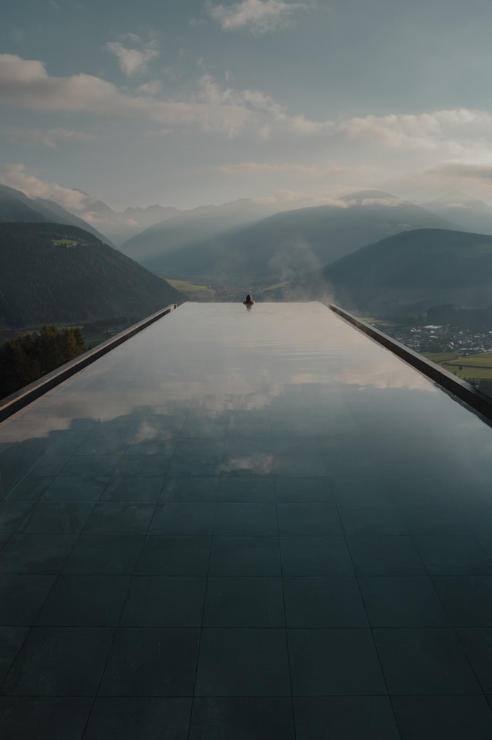 A quiet infinity pool overlooking misty mountains
